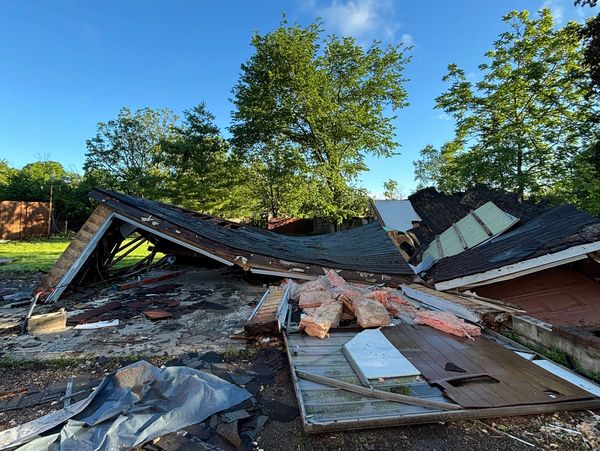 Collapsed building with debris scattered around.