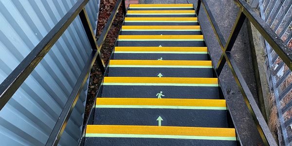stairs with yellow arrows on them