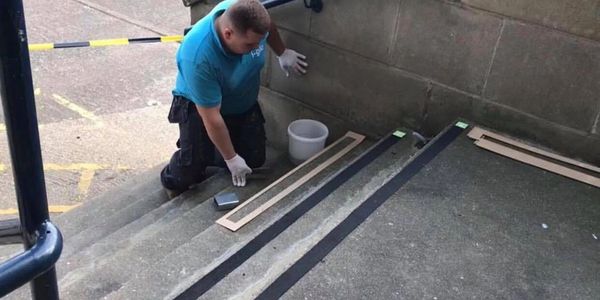 A man working on the steps of a building