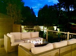 Custom designed and built deck including a gas fire pit and matching outdoor furniture.