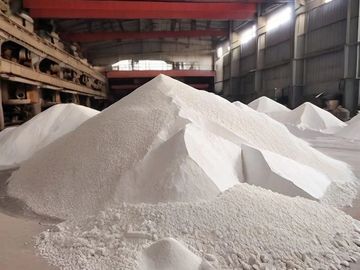 Large piles of white powder stored inside an industrial warehouse.