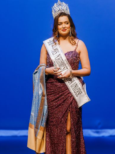 Woman crowned Mrs. Northwest India Universe in a sparkling gown.