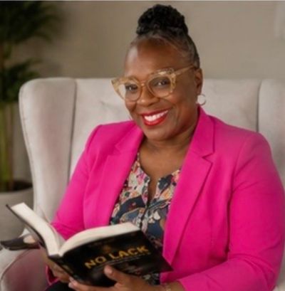 Woman smiling and holding a book.