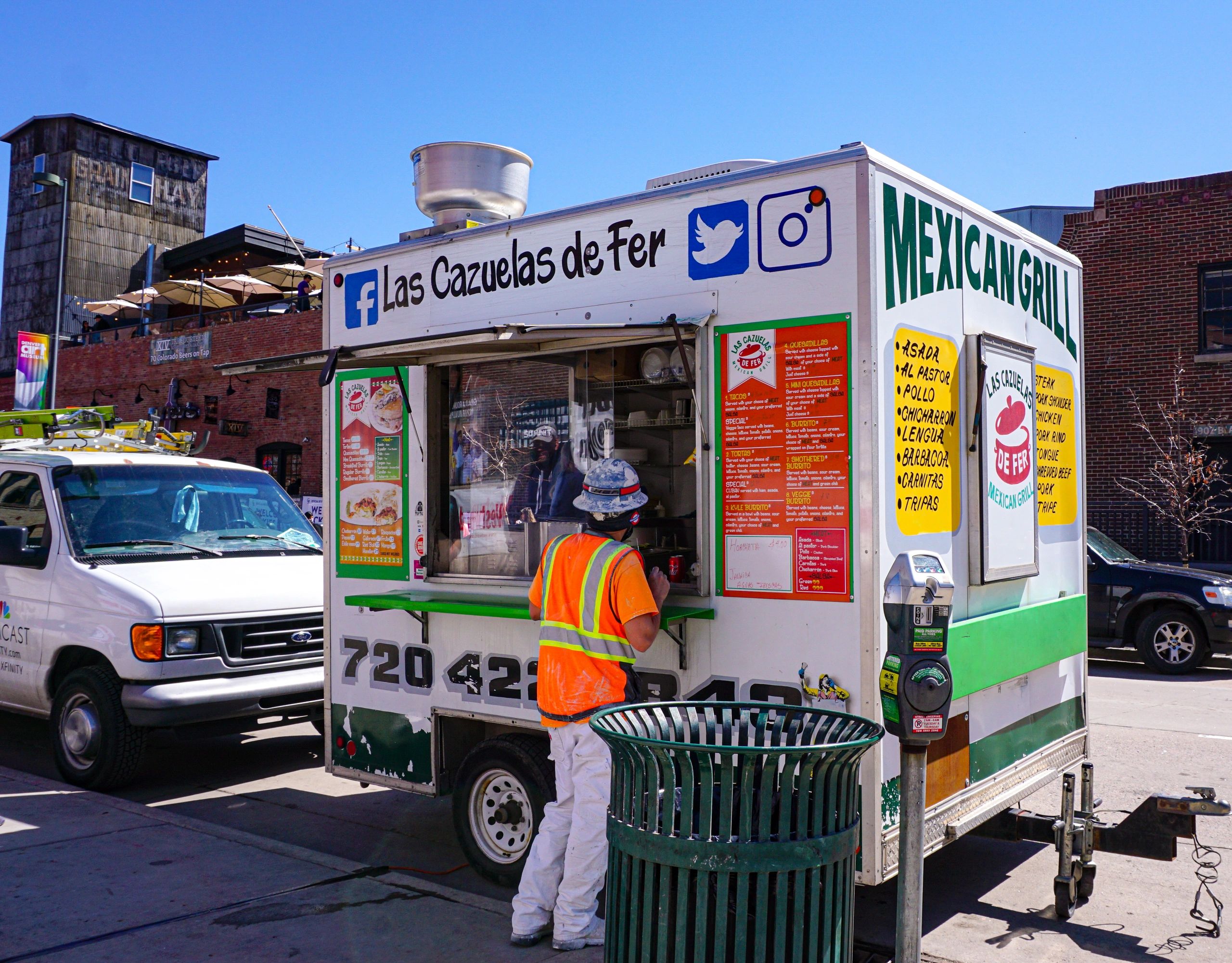A local worker is ordering from the Cazuelas food truck.