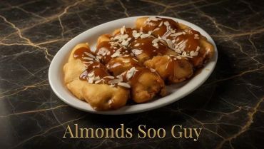 Almonds Soo Guy dessert topped with caramel and shredded almonds.