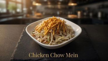 A bowl of chicken chow mein topped with crispy fried noodles.