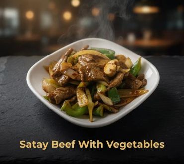 Steaming satay beef stir-fried with colorful vegetables in a white bowl.
