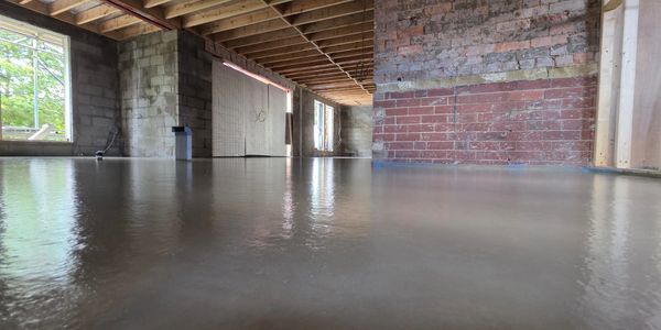 Freshly poured smooth concrete floor in a building under construction.