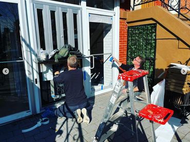 Installing vinyl signs on restaurant window