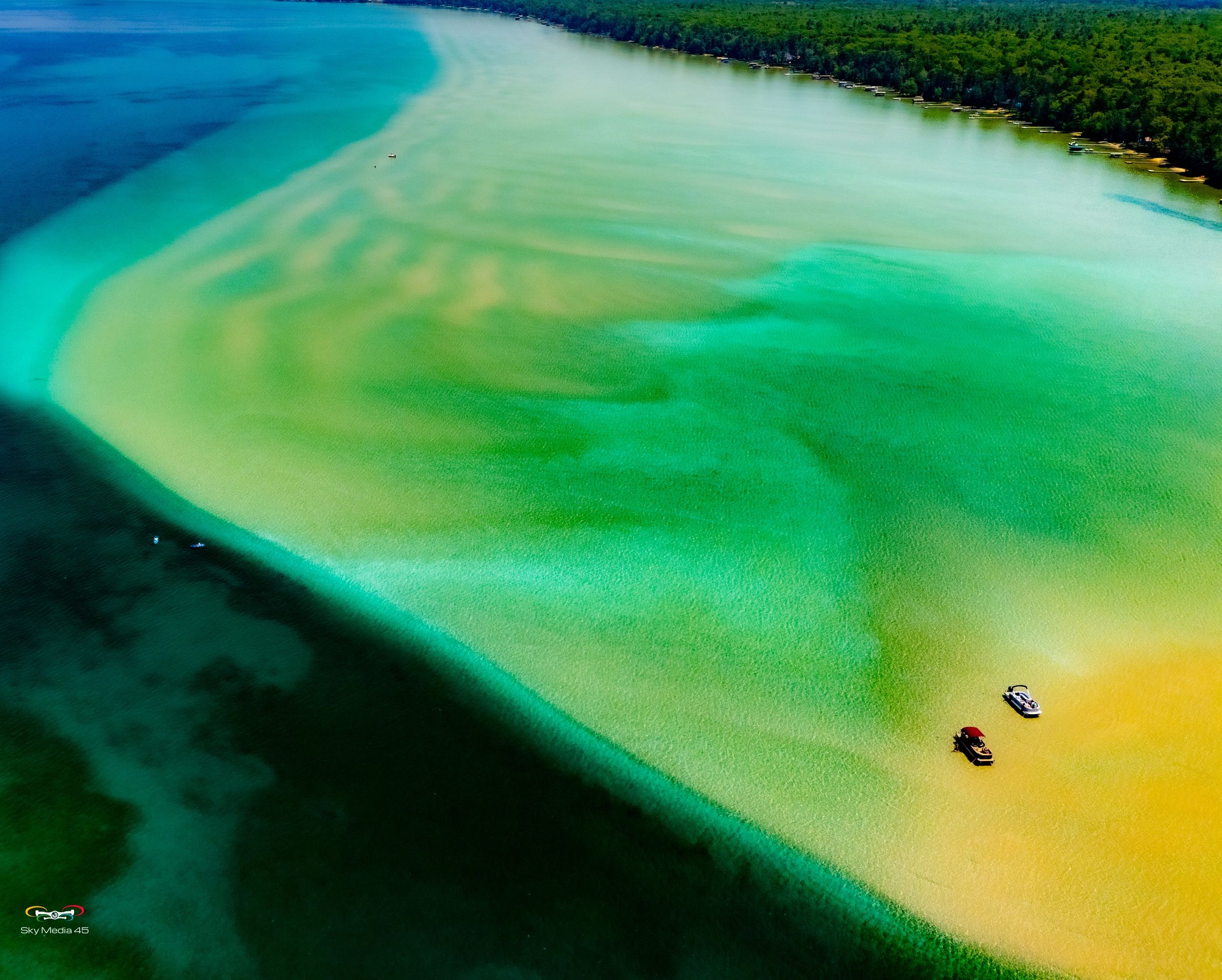 The iconic sandbar at Torch Lake, Mi summertime favorite presents beautiful color contrasts.