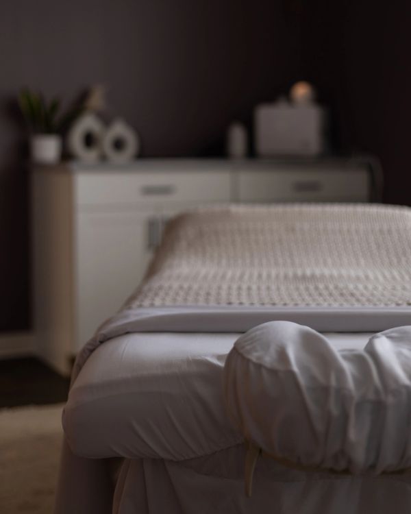 Calm massage table in a softly lit room.