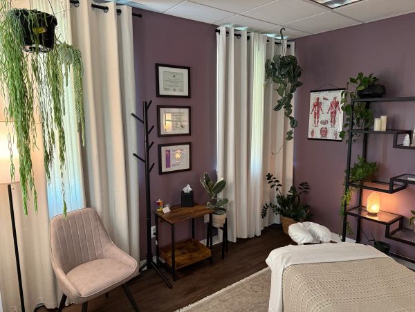 Cozy therapy or massage room with plants and calming decor.