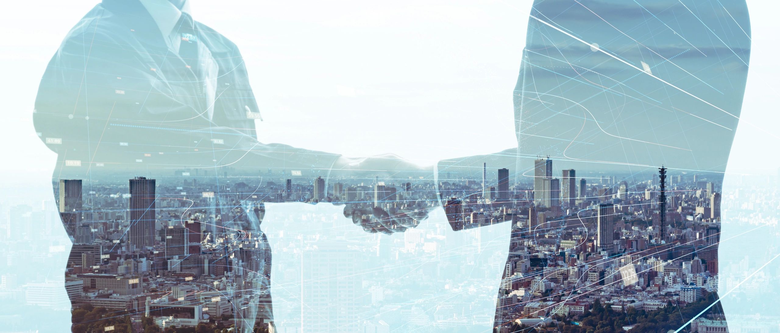 Business handshake overlay with cityscape and digital data.