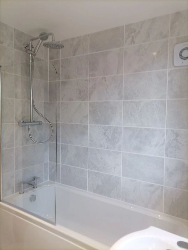 Bathroom refurbishment by bathroom fitters, ceramic tiles, budget bath, quality taps and shower bar.