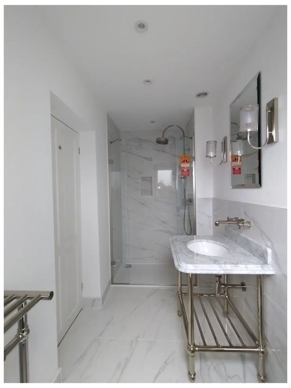 Luxurious marble effect shower room ensuite.