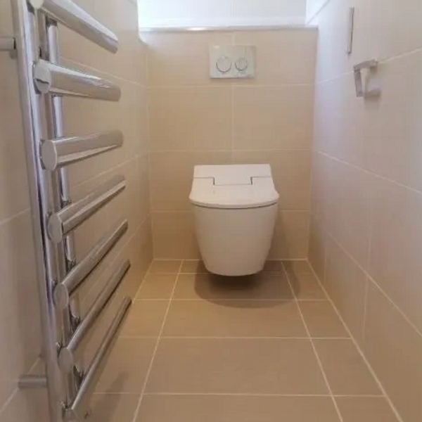 Wall hung toilets, wall and floor tiling, radiator install.