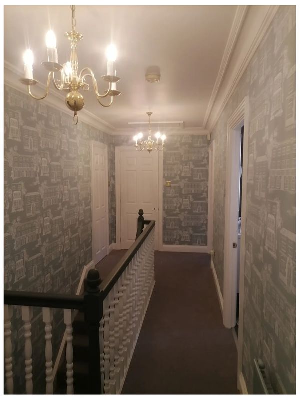Hall, stairs & landing wallpapered wall, white ceiling & coving and satinwood woodwork in Newdigate.