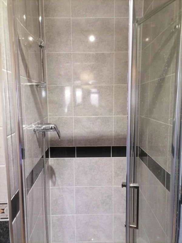 shower cubicle, walls tiled and new shower installed.