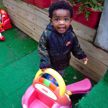 A little boy riding a tricycle