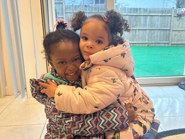 Two little girls hugging