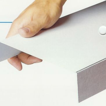 Hand opening a white cardboard box.