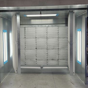 Interior of a metallic industrial booth with lights.