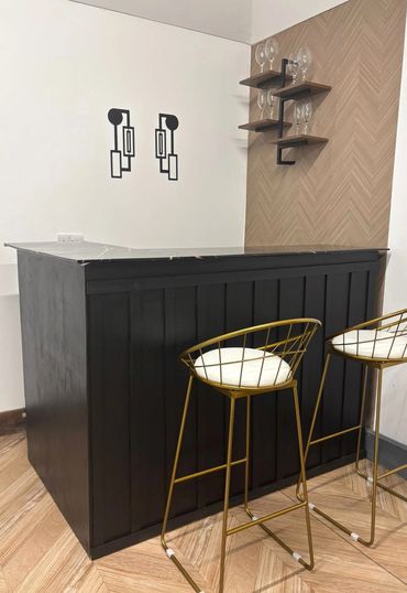 Bar area with two gold stools and wine and champagne wall
