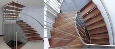 Curved staircase with timber treads, vertical cable balustrades and a wall-mounted handrail.