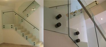 Glass stair panels secured with circular metal mounts.