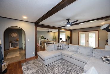 Cozy living room with a large gray sectional sofa and wooden accents.