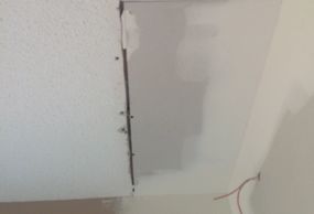 This is a popcorn textured ceiling BEFORE being repaired with a Self Adhesive Popcorn Ceiling Repair Patch.