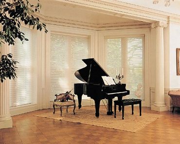 White shades behind a black piano