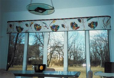 Short floral window draperies in the dining room