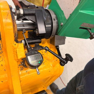 Dial indicator measuring machine part for precision.