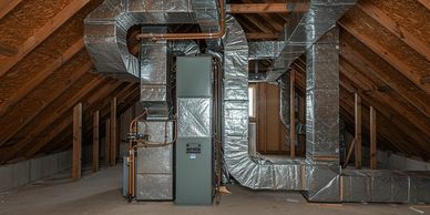 Exposed HVAC ductwork and furnace system in a spacious attic with wooden beams.