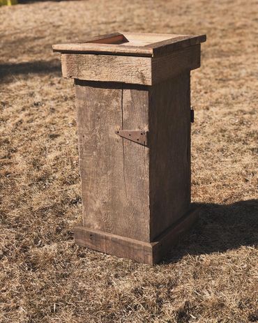 Barnwood square top pedestal with rustic hinge on the side. Built by Nichols Taxidermy Bases