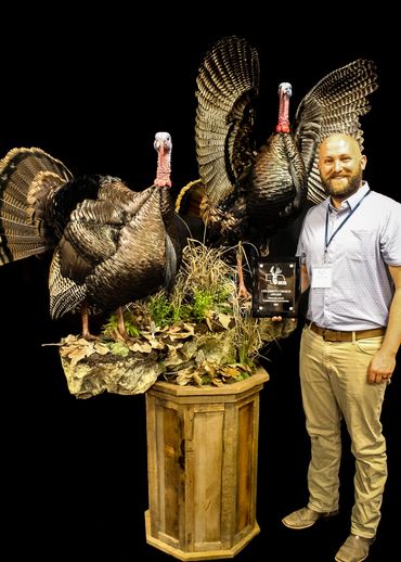 Custom double turkey display on a rustic barnwood octagon pedestal, built by Nichols Taxidermy Bases