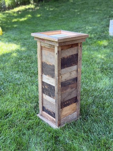 Square barnwood pedestal with custom rustic side paneling.