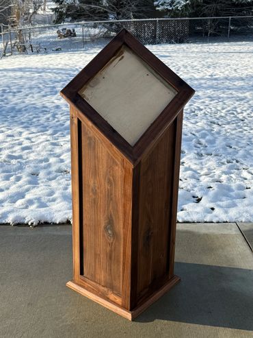 Walnut pedestal for a competition deer mount with slanted top.
