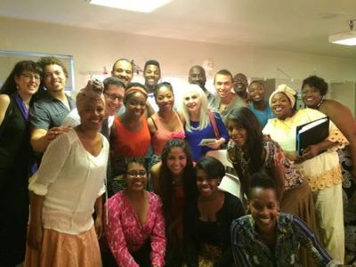 Group of smiling people posing indoors.