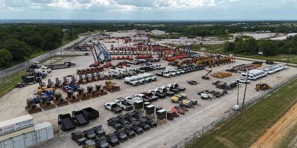 Aerial view of a large construction equipment and vehicle yard.