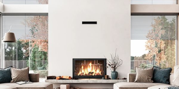 Cozy modern living room with a roaring fireplace and plush seating.