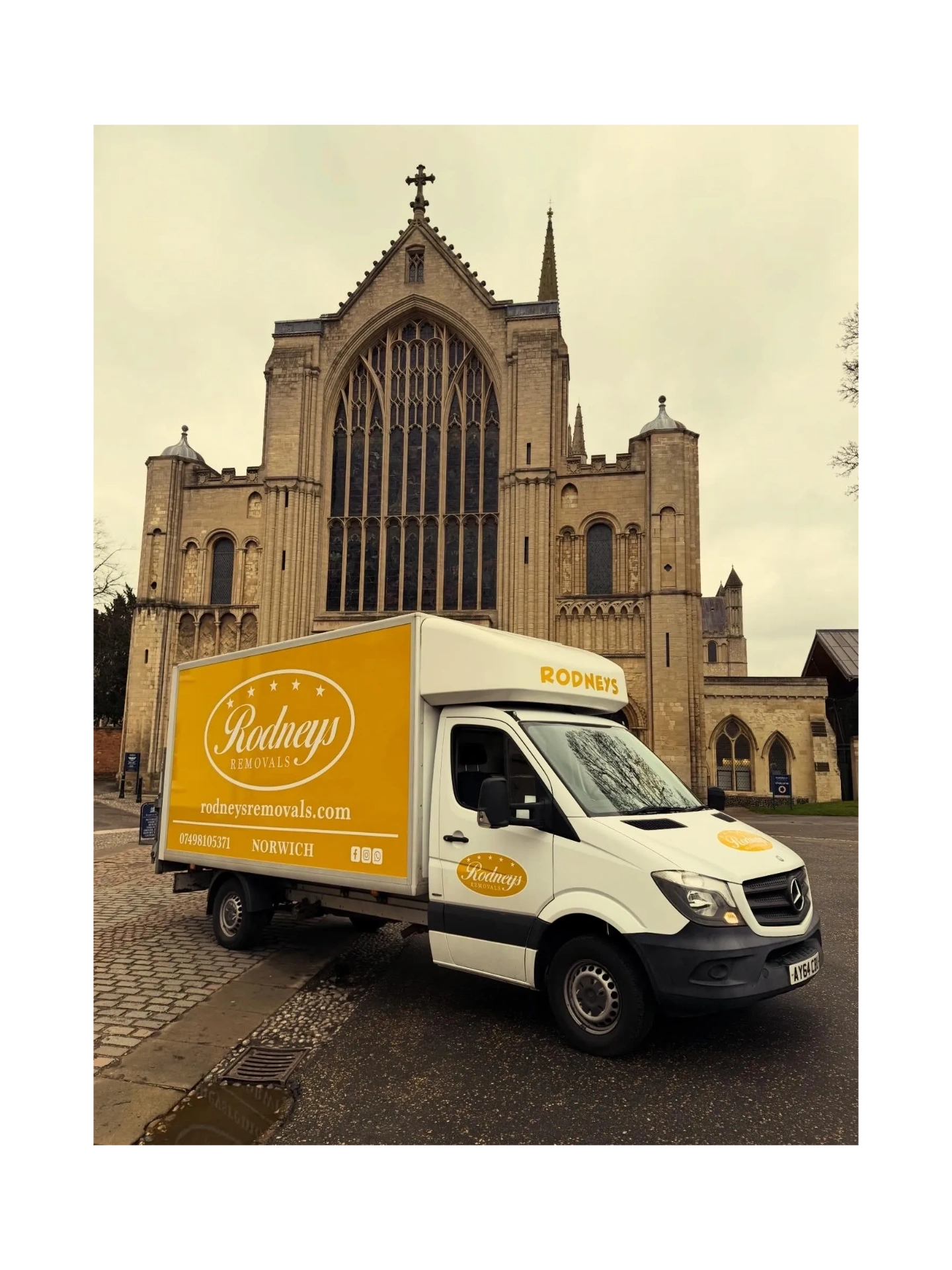 Rodneys Removals truck parked in front of a historic cathedral in Norwich.