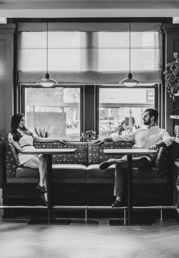A romantic black and white artistic photograph showing silhouettes with falling light from above