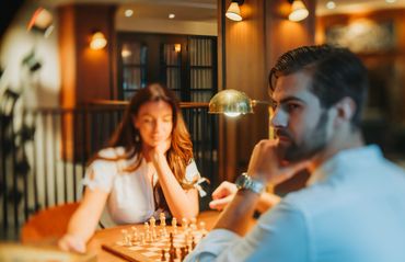 Couple playing chess in the afternoon light.