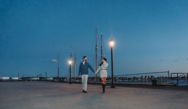 A romantic portrait of a couple sharing an intimate moment under city lights at night