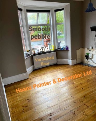 living room with varnished floor and smooth pebble paint on wall, with white gloss on wood work
