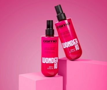 Two pink Osmo Wonder 10 hair treatment bottles on pink blocks.