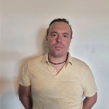 Portrait of the pool boy, JD. Wearing a yellow polo.