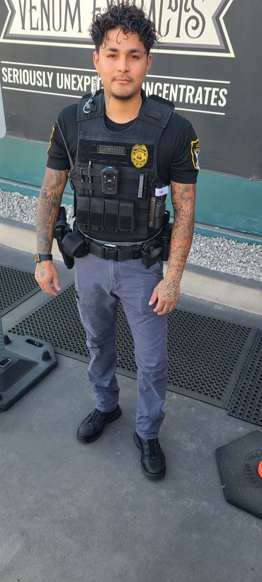 Young man in police uniform with tattoos.